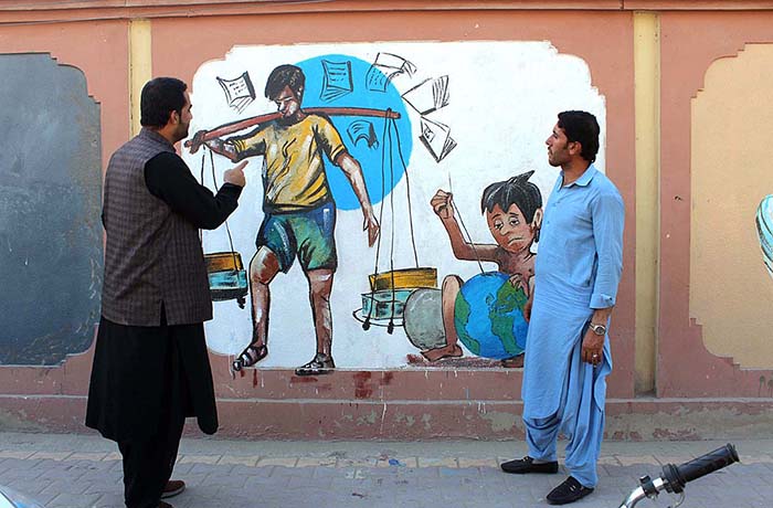 Young people watching beautiful sight of paint on wall of Deputy Commissioner Office.